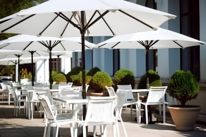 Outdoor Cafe with White Umbrellas, Tables and Chairs