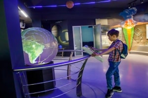 Young School Boy Enjoying Play and Learn Activities in Museum of Science