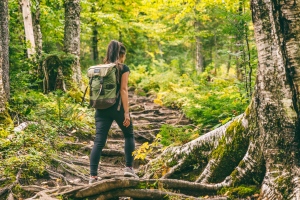 Girl with Backpack Walking on A Trail